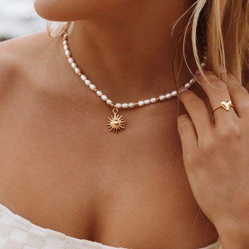 sun-pendant-gold-necklace-on-model